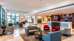 Modern hotel lobby in Silver Spring with contemporary furnishings, comfortable seating areas, warm lighting, and welcoming reception desk with professional staff greeting guests