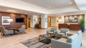 Modern hotel lobby with comfortable seating, warm lighting, and welcoming front desk area in Connecticut hotel setting