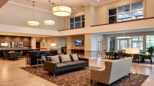 Modern hotel lobby with elegant furnishings, comfortable seating areas, and contemporary lighting fixtures in a mid-range Spartanburg hotel setting