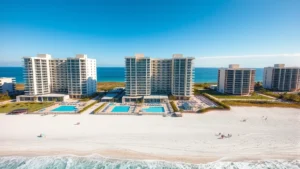 Bright oceanfront beachfront resort with multiple towers and outdoor swimming pools overlooking the Atlantic Ocean, sunny day with clear blue sky, families enjoying the sandy beach in front of modern hotel complex