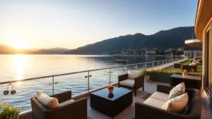 Elegant lakeside hotel terrace overlooking Lake Zurich with Alpine mountains in background, modern furniture, calm water reflecting sunset light, peaceful residential atmosphere