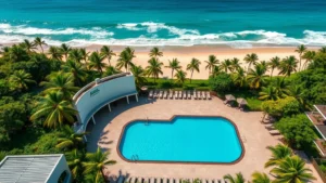 Aerial view of a modern beachfront resort with swimming pool overlooking Pacific Ocean, tropical vegetation, and sandy beach in El Salvador coastal area