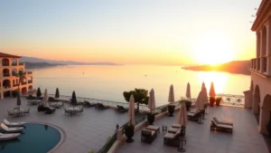 Serene lakeside hotel terrace overlooking calm water at sunset, elegant outdoor seating with lounge chairs and umbrellas, Mediterranean architecture, no people visible, golden hour lighting