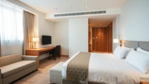 Modern hotel room interior with comfortable furnishings, clean linens, soft lighting, and private ambiance showing a typical guest accommodation space