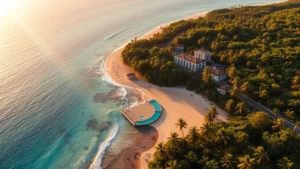 Aerial view of lush tropical rainforest meeting golden sandy beach with turquoise Caribbean waters, resort buildings nestled among palm trees and vegetation, morning sunlight