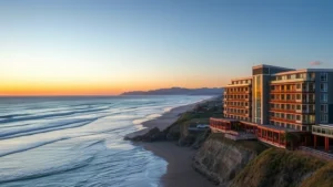 Oceanfront hotel with modern architecture overlooking sandy beach and Pacific Ocean waves at sunset, coastal Oregon landscape, no signage or text visible