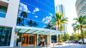 Modern downtown Miami hotel exterior with contemporary architecture, glass facade reflecting blue sky and palm trees, professional entrance with bellhop assisting guests with luggage, bright daylight